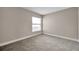 A bright bedroom features neutral walls and carpet, with a window offering natural light at 5306 Marlwood Ct, Tampa, FL 33624