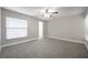 Bright bedroom with large window, ceiling fan, neutral color and access to bathroom at 5306 Marlwood Ct, Tampa, FL 33624