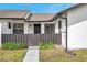 Charming front entrance features secure front entry with a dark brown fence and blue skies at 5306 Marlwood Ct, Tampa, FL 33624