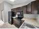 Updated kitchen with dark cabinets and modern appliances at 5306 Marlwood Ct, Tampa, FL 33624