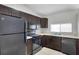 Cozy kitchen featuring dark cabinetry and stainless steel appliances at 5306 Marlwood Ct, Tampa, FL 33624