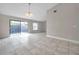Open concept living room with tile flooring and a sliding glass door at 5306 Marlwood Ct, Tampa, FL 33624
