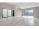 Open concept living room with glass sliding doors and tile flooring at 5306 Marlwood Ct, Tampa, FL 33624