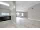 Open floor plan featuring tile flooring, a kitchen and a sliding glass door at 5306 Marlwood Ct, Tampa, FL 33624
