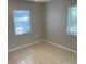 Bright bedroom with tiled floors and windows, offering natural light at 6102 Massachusetts Ave, New Port Richey, FL 34653