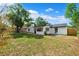 Backyard featuring a white home exterior, green grass, and a grill at 622 Cedar Grove Dr, Brandon, FL 33511