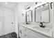 Modern bathroom featuring dual vanity sinks, quartz countertops, and matte black fixtures, combining style and functionality at 622 Cedar Grove Dr, Brandon, FL 33511