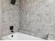 Elegant bathroom with a tub-shower combo featuring gray tiling and matte black fixtures, providing a tranquil and modern space at 622 Cedar Grove Dr, Brandon, FL 33511