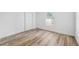 Bedroom with light wood floors, a window, and a closet with bi-fold doors at 622 Cedar Grove Dr, Brandon, FL 33511