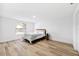 Serene bedroom showcasing natural light, neutral decor, and light hardwood floors, creating a relaxing atmosphere at 622 Cedar Grove Dr, Brandon, FL 33511