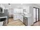 Bright kitchen featuring stainless steel appliances, bright white cabinets, and light countertops and backyard access at 622 Cedar Grove Dr, Brandon, FL 33511