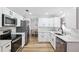 Modern kitchen featuring stainless steel appliances, bright white cabinets, and light countertops at 622 Cedar Grove Dr, Brandon, FL 33511