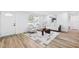 Bright living room featuring natural light, modern decor, light wood floors, and a comfortable seating area at 622 Cedar Grove Dr, Brandon, FL 33511