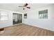 Bright room featuring light wood floors, sliding glass doors, and a ceiling fan at 622 Cedar Grove Dr, Brandon, FL 33511