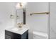 Modern bathroom featuring gold fixtures, a vanity sink, and lighting at 6240 Keller Dr, Port Richey, FL 34668
