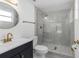 Stylish bathroom featuring a glass shower, modern vanity, and elegant gold fixtures at 6240 Keller Dr, Port Richey, FL 34668