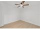 Bright bedroom featuring a ceiling fan and light-colored wood floors at 6240 Keller Dr, Port Richey, FL 34668