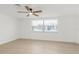 Bedroom with a window allowing ample natural light and light-colored wood floors at 6240 Keller Dr, Port Richey, FL 34668