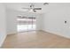 Spacious bedroom with light wood floors and sliding glass doors overlooking the pool at 6240 Keller Dr, Port Richey, FL 34668