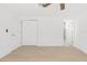 Clean bedroom featuring wood flooring, ceiling fan, closet, and a bathroom at 6240 Keller Dr, Port Richey, FL 34668