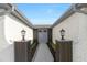 Inviting front entrance with stylish gray double doors and decorative lighting fixtures at 6240 Keller Dr, Port Richey, FL 34668