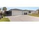 Spacious driveway leading to a two-car garage with stylish, modern privacy fencing at 6240 Keller Dr, Port Richey, FL 34668