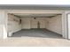 Spacious two car garage with water heater, epoxy floor, shelving and interior access door to the home at 6240 Keller Dr, Port Richey, FL 34668