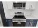 Modern kitchen with stainless steel appliances, quartz countertops, and sleek cabinets at 6240 Keller Dr, Port Richey, FL 34668