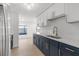 Stylish kitchen with modern white cabinets, quartz countertops, and stainless steel appliances at 6240 Keller Dr, Port Richey, FL 34668