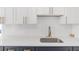 Well-appointed kitchen featuring quartz countertops, ample cabinet space, and updated faucet fixtures at 6240 Keller Dr, Port Richey, FL 34668