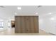 Spacious living area featuring a fireplace, a modern wood divider, and a neutral color palette at 6240 Keller Dr, Port Richey, FL 34668