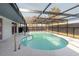 Screened-in pool with clear blue water and a deck area at 6240 Keller Dr, Port Richey, FL 34668