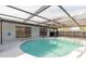 Screened-in pool with clear blue water and a pool-side deck at 6240 Keller Dr, Port Richey, FL 34668