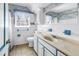 A bathroom featuring a single sink vanity, with a window and a toilet at 6441 27Th N Ave, St Petersburg, FL 33710