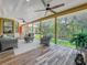 Expansive screened-in back porch with ceiling fans and views of lush greenery at 66 Bay Woods Dr, Safety Harbor, FL 34695