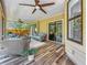 Relaxing screened-in back porch features comfortable seating and sliding glass doors at 66 Bay Woods Dr, Safety Harbor, FL 34695