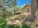 The back of the home is framed by a terraced backyard, lush landscaping and trees at 66 Bay Woods Dr, Safety Harbor, FL 34695