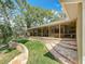 A tiered backyard features lush landscaping, mature trees and an inviting back porch at 66 Bay Woods Dr, Safety Harbor, FL 34695
