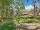 A home with lush landscaping, a terraced backyard, and a screened-in porch at 66 Bay Woods Dr, Safety Harbor, FL 34695