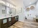 Stylish bathroom featuring double sinks, modern fixtures, and standalone tub at 66 Bay Woods Dr, Safety Harbor, FL 34695