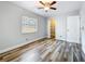 Clean bedroom with wood floors, ceiling fan, and closet with shelving at 66 Bay Woods Dr, Safety Harbor, FL 34695