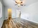 Bright bedroom features wood-look tile floors, a ceiling fan, and an open closet at 66 Bay Woods Dr, Safety Harbor, FL 34695