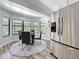 Breakfast nook featuring a round table with a stainless steel refrigerator in the background at 66 Bay Woods Dr, Safety Harbor, FL 34695