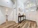 Welcoming foyer with high ceilings, wood-look tile flooring, and an elegant console table at 66 Bay Woods Dr, Safety Harbor, FL 34695