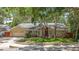Charming single-story home with lush landscaping, a brick-accented facade, and a well-maintained front yard at 66 Bay Woods Dr, Safety Harbor, FL 34695