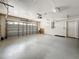 Spacious garage with epoxy floor and storage on the wall and ceiling at 66 Bay Woods Dr, Safety Harbor, FL 34695
