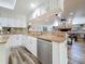 Kitchen showcasing granite countertops, stainless steel dishwasher and view to living room at 66 Bay Woods Dr, Safety Harbor, FL 34695