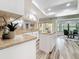 Well-lit kitchen with granite countertops, white cabinetry, and a breakfast nook area at 66 Bay Woods Dr, Safety Harbor, FL 34695