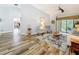 Spacious living room featuring wood-look tile flooring, stylish furnishings, and ample natural light at 66 Bay Woods Dr, Safety Harbor, FL 34695