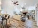 Spacious living room featuring a brick fireplace, vaulted ceiling, and access to the kitchen at 66 Bay Woods Dr, Safety Harbor, FL 34695